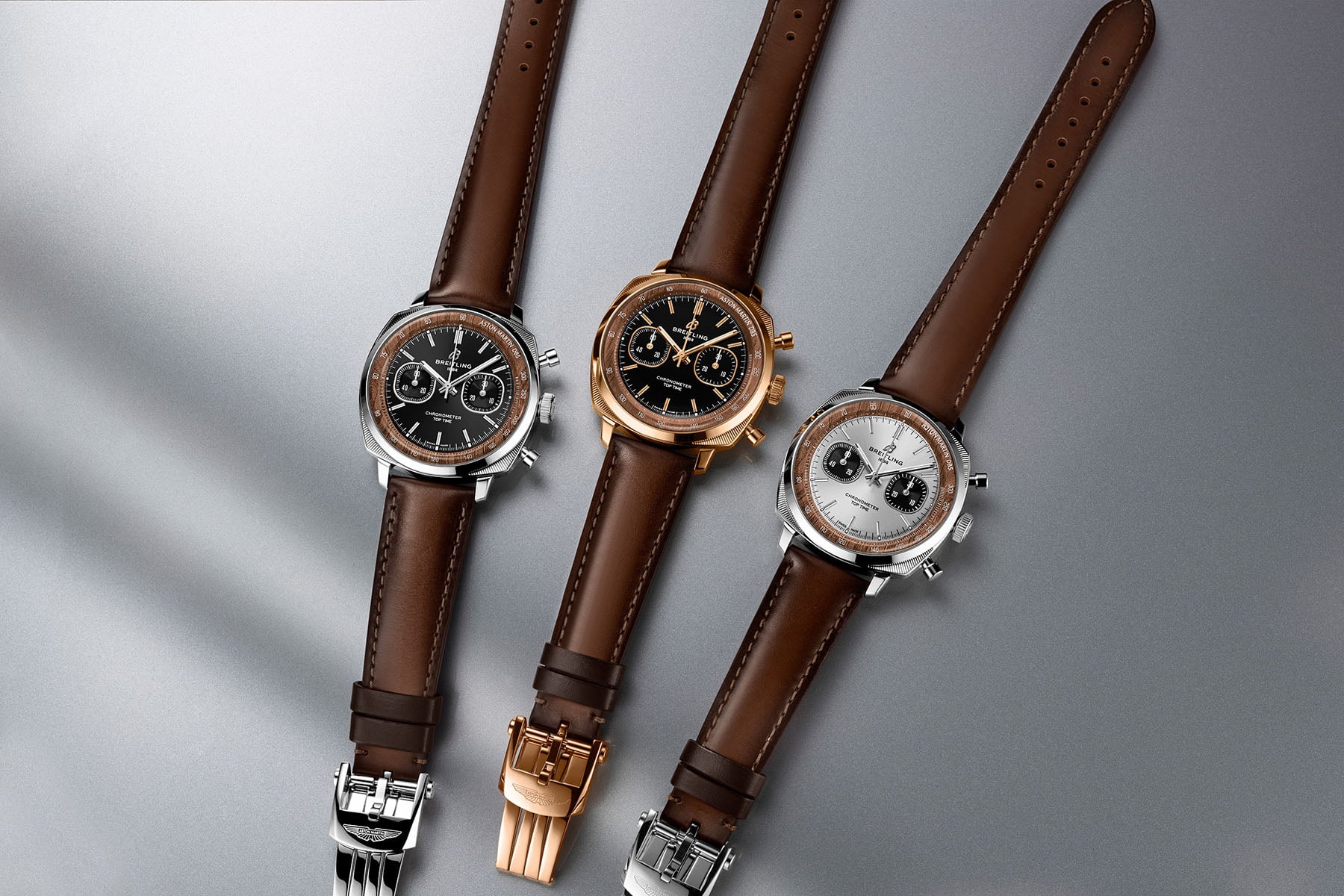 Full Breitling Top Time Aston Martin DB5 trio: steel, steel with platinum bezel, and red gold, shown side by side